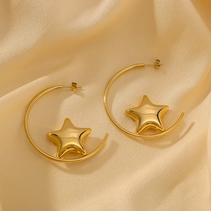 Polished 18k gold plated C-shaped hollow star earrings on elegant champagne silk