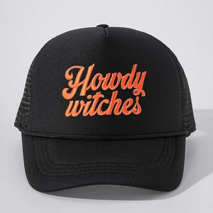 Detail of Howdy Witches orange embroidery and braided rope on a black trucker hat