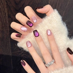Handmade cat eye press-on nails in deep purple with glitter accents and flower ring