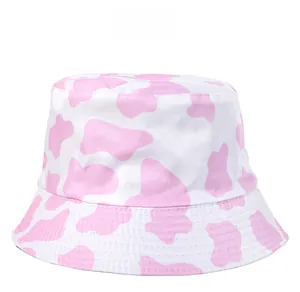Close-up of pink cow print texture on soft cotton fabric of a stylish bucket hat