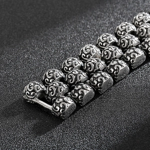 Macro shot of vintage silver men's chunky stainless steel bracelet with ornate carvings