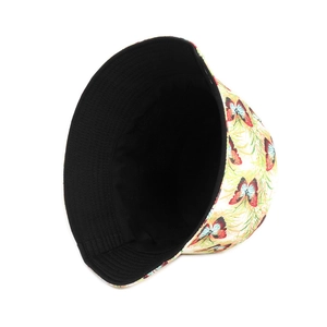 Detailed view of the butterfly print and black reversible fabric of this summer sun hat