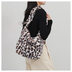 Detail of soft leopard print plush tote bag with wide shoulder strap worn by model