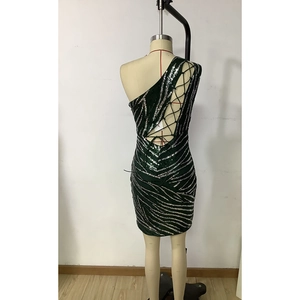Close-up of the backless cross-strap design on this sequined dark green party dress
