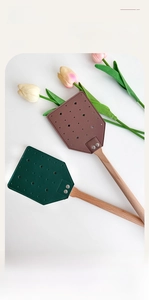 Detail of beech wood handle and leather fly swatter head with star pattern stitching
