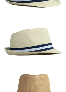 Close-up of the woven straw texture and blue striped ribbon on the fedora hat