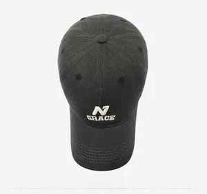 Top view of dark grey denim baseball cap with white embroidered N GRACE logo detail