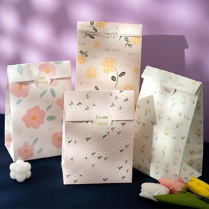 Floral paper gift bags set with round stickers for children's birthday celebrations
