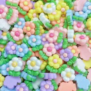 Macro view of assorted colorful resin mini flowers for DIY nail art and craft making