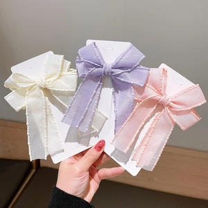 Three-piece set of mesh bow hair clips in cream, lavender and pink for girls