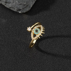 Macro view of gold evil eye open ring with white zircon pave and blue gemstones