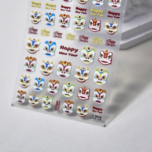 Macro detail of 3D embossed lion dance nail stickers with Happy New Year lettering