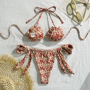 Detailed flat lay of leopard print bikini set with stylish summer beach accessories