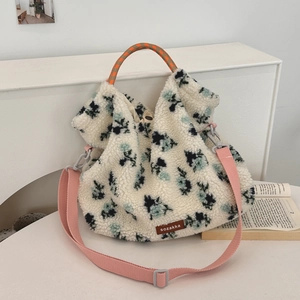 Detail of plush faux shearling tote bag with floral patterns and a contrast handle