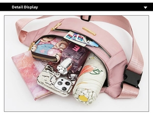 Macro view of pink nylon fanny pack showing large capacity for phone, wallet and umbrella