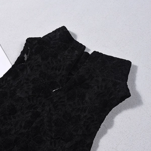 Detail of black lace bodysuit featuring floral embroidery and back zipper closure
