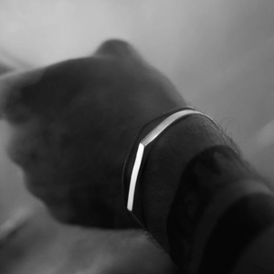 Minimalist silver stainless steel bangle bracelet for men featuring a sleek polished finish