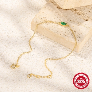 Detail of gold-plated S925 silver bracelet with marquise-cut green zircon and adjustable chain
