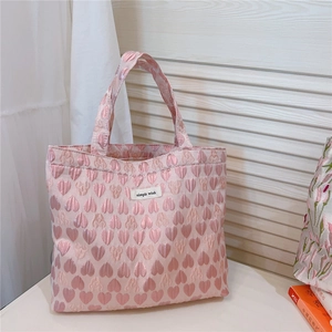 Close-up of pink heart jacquard fabric and simple wish label on the tote bag