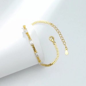Detailed close-up of S925 sterling silver stamp on golden bracelet with rectangle zircons