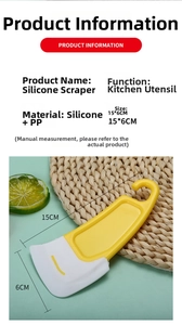 Close-up of silicone scraper with yellow handle and white blade for kitchen cleaning