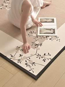 Close-up of Chinese floral rug showing fine weave texture and elegant black stitched edges