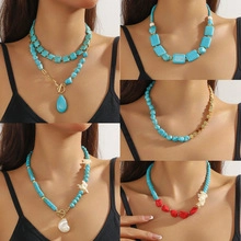 Detail showing various turquoise beaded necklaces with gold accents and mixed stone shapes