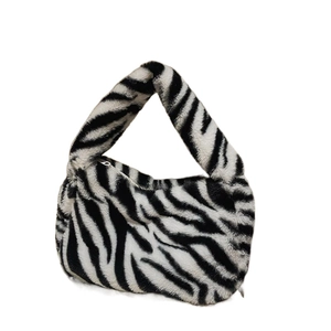 Chic zebra print plush crossbody bag with soft faux fur and silver zipper detailing