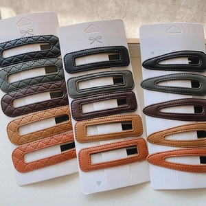 Set of 5 minimalist PU leather hair clips in diverse colors on a white display card