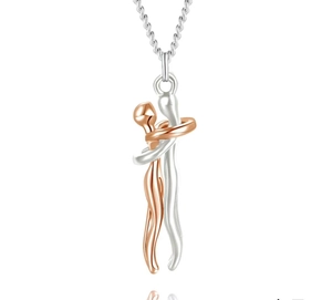 Close-up of two-tone hugging couple pendant in silver and rose gold finish