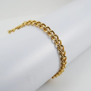 Detailed close-up of 18K gold-plated stainless steel Cuban link chain with OT clasp