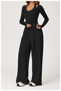 Detail of black wrap-style long sleeve yoga top and high-waist wide-leg fitness pants