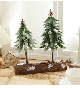 Close-up of mini snowy Christmas trees on a natural wooden base for desktop decoration