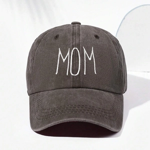 Close-up of white MOM embroidery on dark gray washed cotton baseball cap with ventilation holes