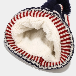 Detail view of the soft white fleece lining and striped knit texture on winter hats