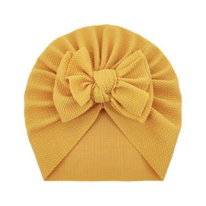 Turbante para bebé amarillo jengibre con lazo grande y tela elástica con textura