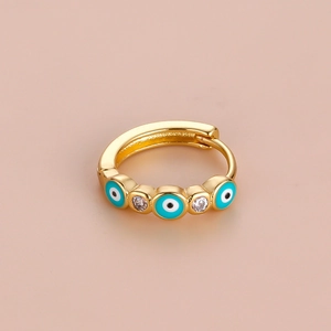 Detailed shot of bohemian gold hoop earring with blue evil eyes and cubic zirconia