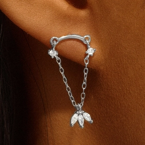 Silver chain drop earring with sparkling zircon leaves shown on model ear cartilage