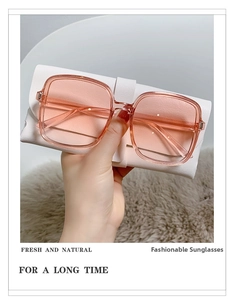Pink oversized square sunglasses with gradient lenses and white folding leather case
