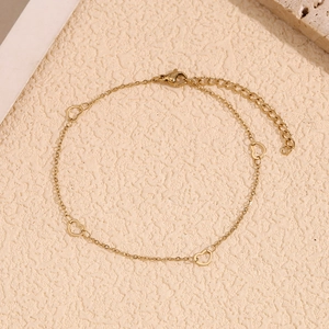 Detailed view of the 14K gold plated anklet featuring hollow heart pendants and lobster clasp