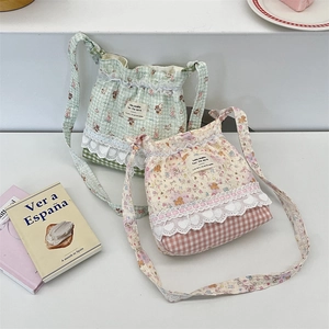 Detail view of cotton crossbody bags featuring lace trim and cute animal floral prints