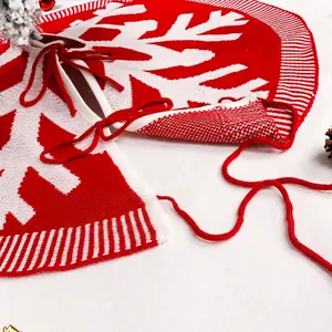 Soft red and white knitted Christmas tree skirt featuring large snowflake patterns