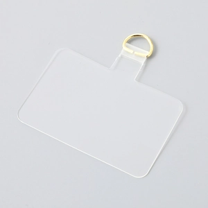 Detailed view of clear TPU phone lanyard patch with a sturdy gold metal D-ring attachment