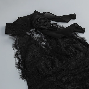 Detail of black lace halter neck dress featuring 3D rose ornament and eyelash lace edges