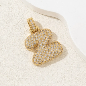 Detail of chubby letter Z pendant with gold plating and sparkling cubic zirconia crystals