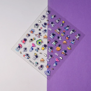Detail of 3D cartoon astronaut and planet nail stickers with vibrant colors on split background