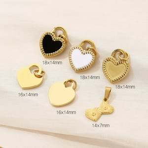 Sweet heart-shaped stainless steel pendants in various sizes and colors displayed on fabric