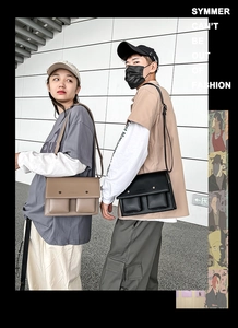 Modern outdoor lifestyle shot of dual-pocket messenger bags in black and khaki