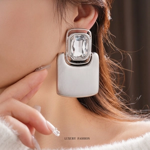 Luxe silver rectangle crystal earrings with brushed metal finish shown on model