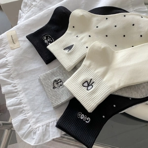 Detail of soft cotton socks with cute bear embroidery and classic polka dot patterns